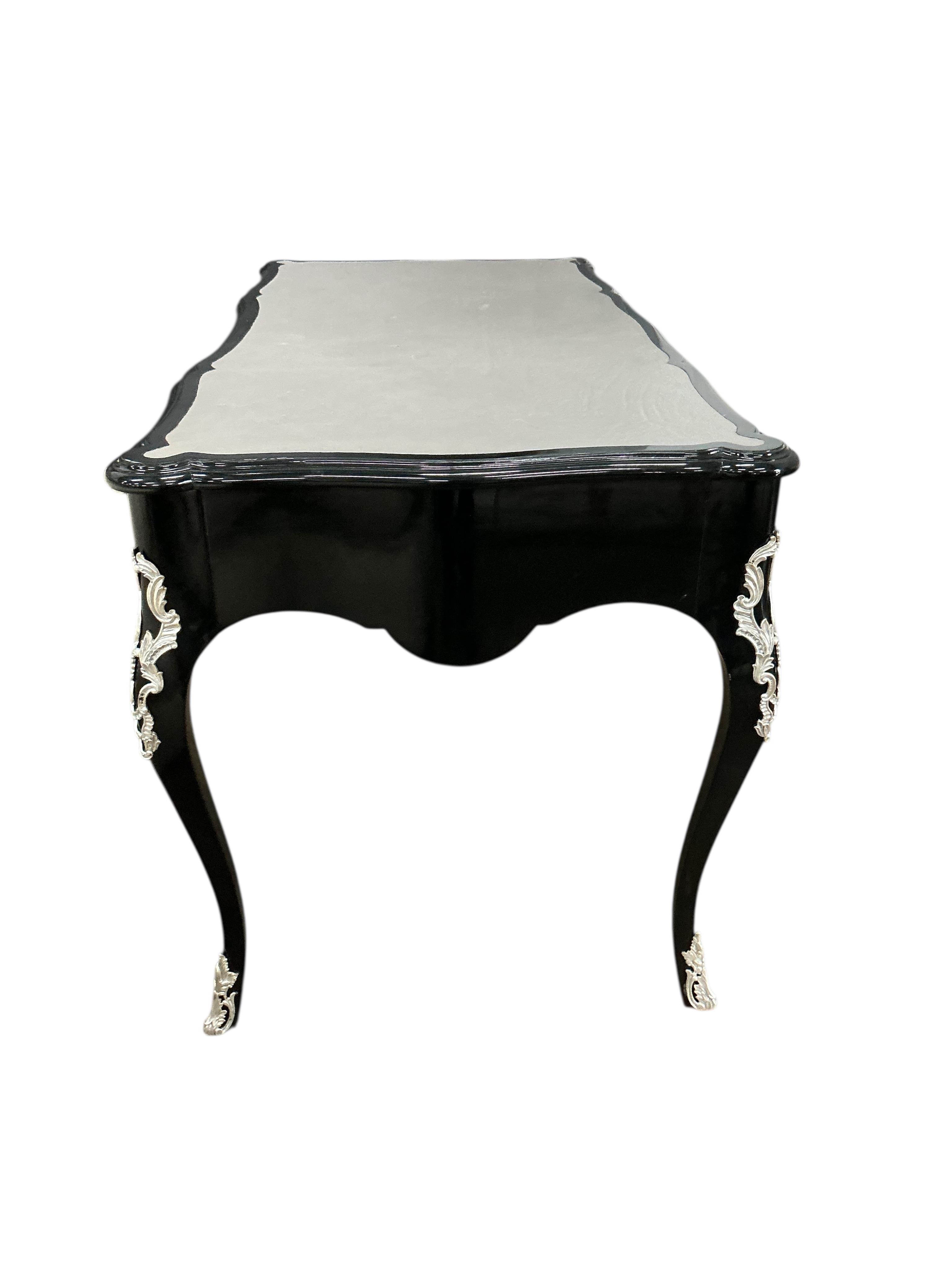 A Contemporary Louis XVI style ebonised bureau plat, width 146cm, depth 71cm, height 79cm